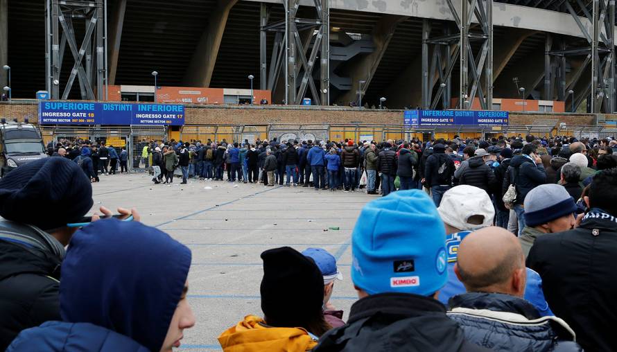 Supporters queue to enter San Paolo stadium before the start of the Champions League soccer match Napoli vs Real Madrid in Naples