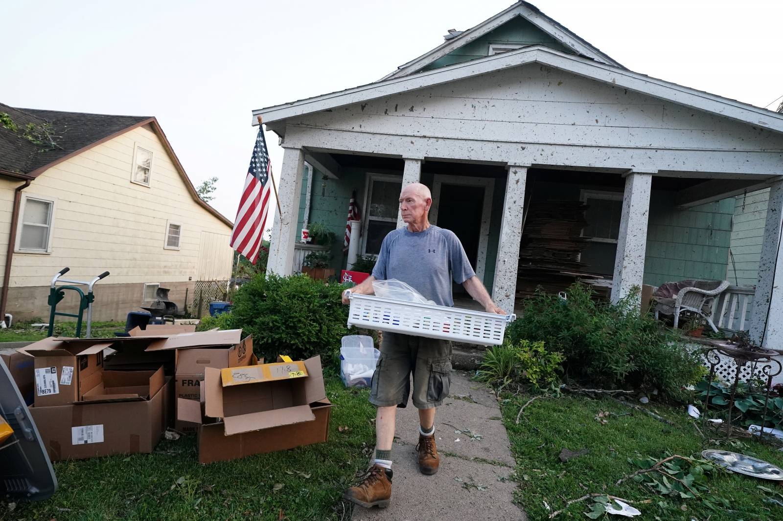 A man rescues items from a home following a tornado in Jefferson City