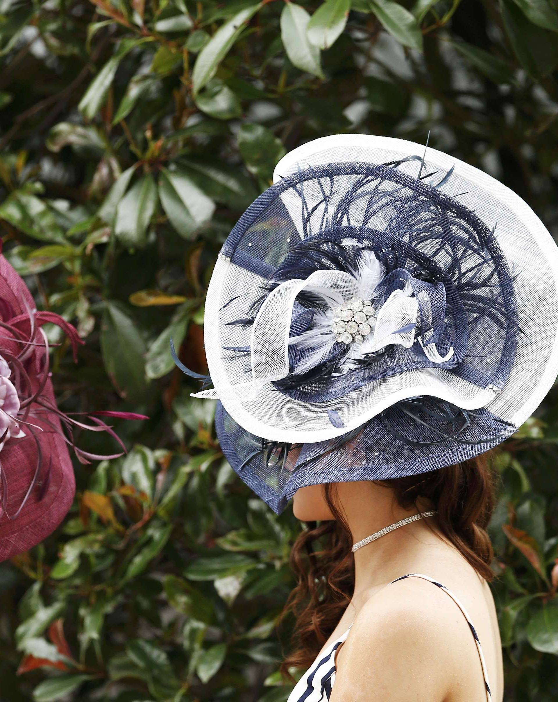 Britain Horse Racing Ladies Day Racegoer wears hat