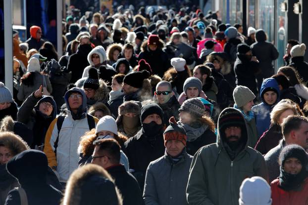 Crowds walk through Times Square as a cold weather front hits the region in Manhattan