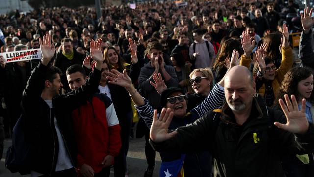 People take part in a protest against the imprisonment of Catalan separatist leaders outside Sants train station in Barcelona