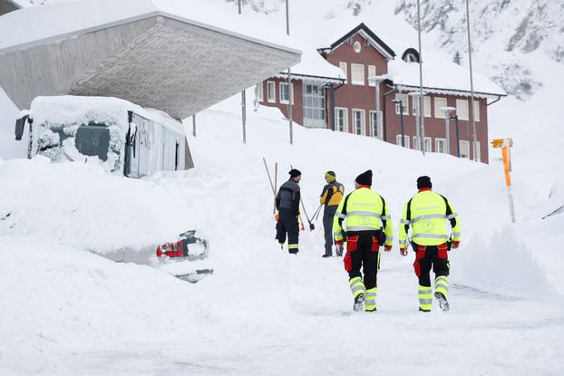 A snow-covered bus stands at Santis-Schwaegalp mountain area after an avalanche