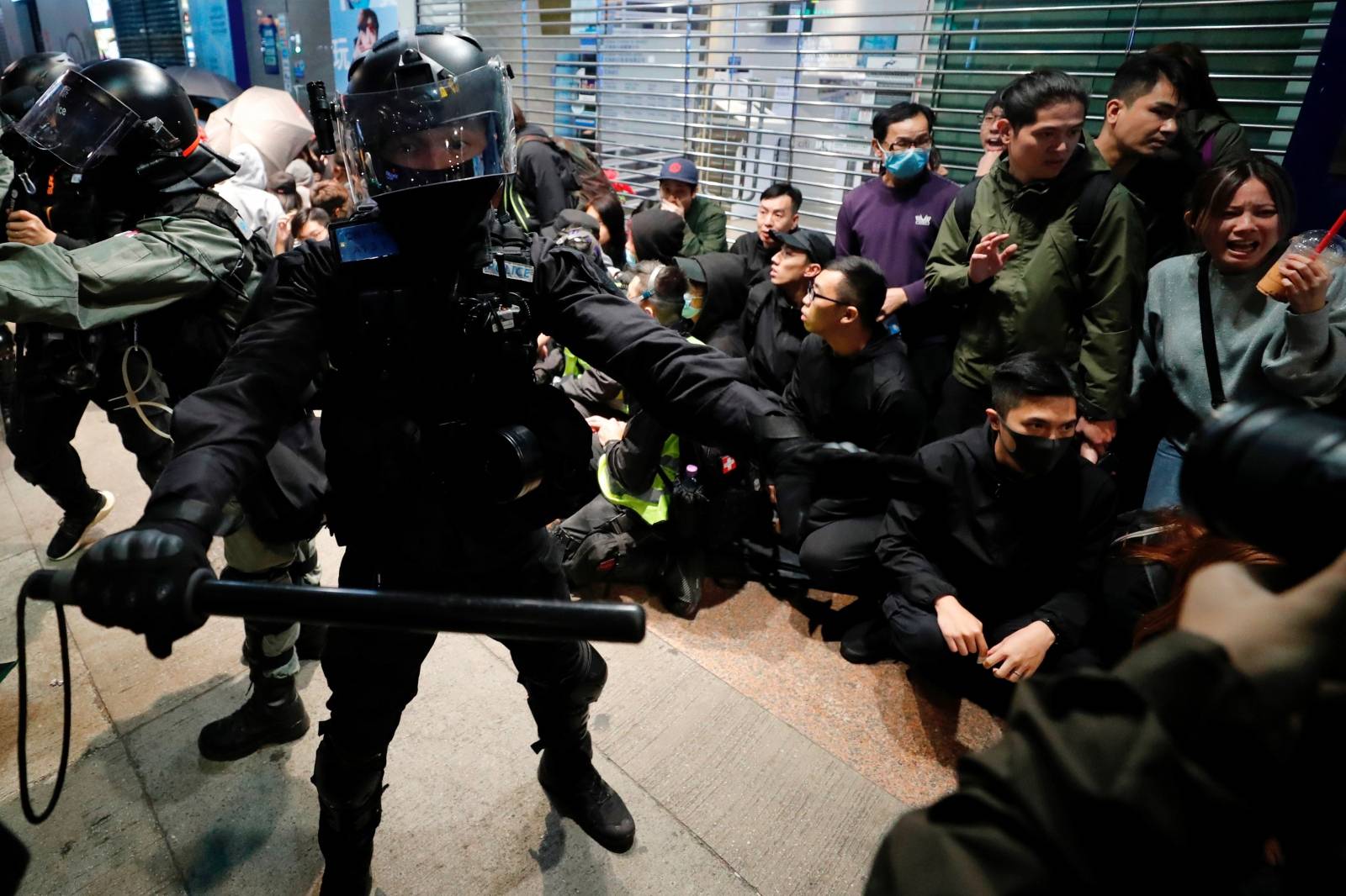 Riot police detain anti-government protesters in a large scale during a legal demonstration on the New Year's Day to call for better governance and democratic reforms in Hong Kong