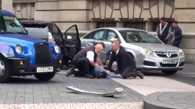 A man is being arrested by police near the Natural History Museum, in London, Britain, in this still image from a video