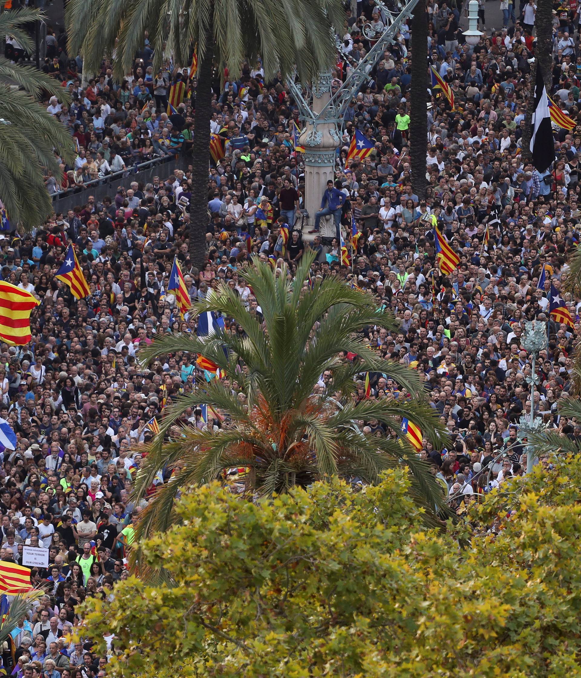 People attend a pro-indpendence rally near the Catalan regional parliament in Barcelona