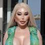 Former Human Ken doll Jessica Alves is pictured showing off her surgically enhanced cleavage while enjoying lunch in Ibiza.
