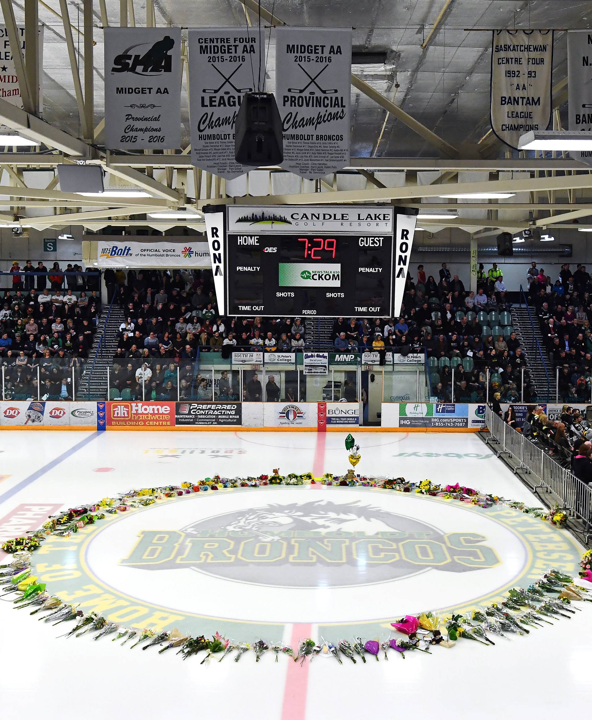 Flowers lie at centre ice as people gather for a vigil at the Elgar Petersen Arena, home of the Humboldt Broncos, to honour the victims of a fatal bus accident in Humboldt