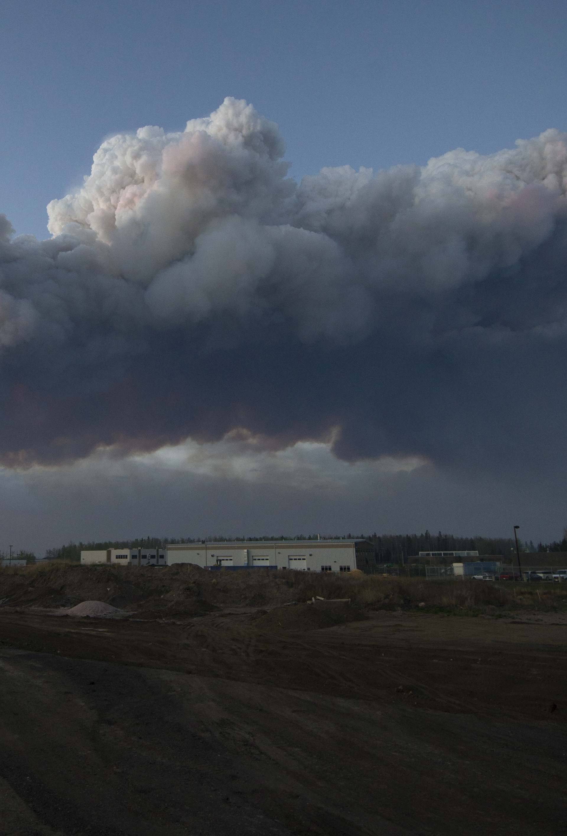 A massive plume of smoke from a wildfire north of the city stretches over Fort McMurray Alberta