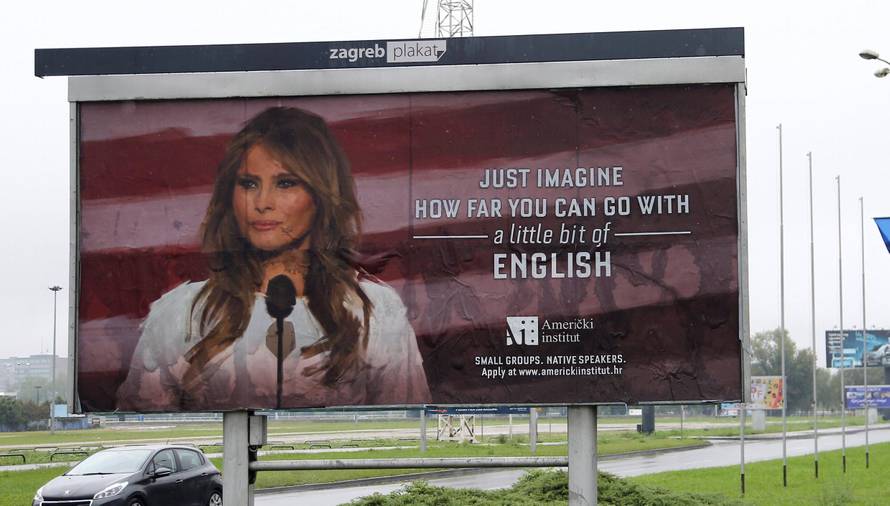 Cars drive near a billboard advertising a language school with the image of U.S. first lady Melania Trump in Zagreb, Croatia