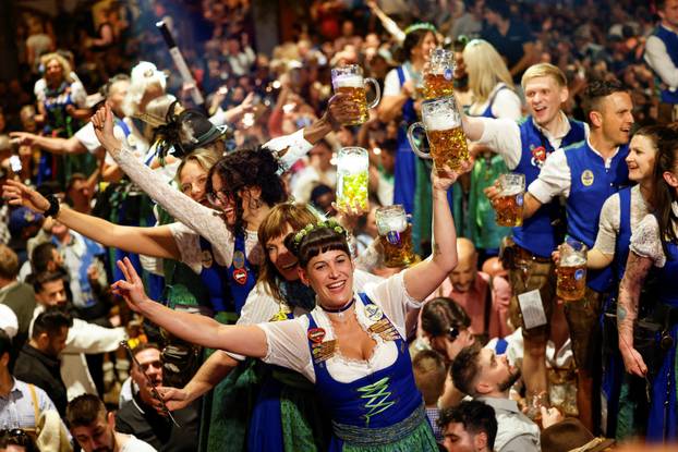 Oktoberfest waitresses toast with beer while they celebrate the end of the 189th Oktoberfest in Munich