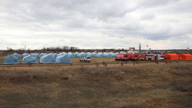 People flee from Ukraine to Moldova at the border crossing in Palanka