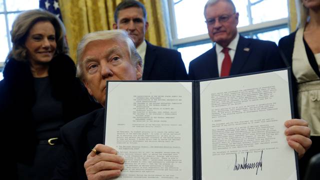Trump holds an executive order dealing with the structure of the National Security Council after signing it in the Oval Office at the White House in Washington