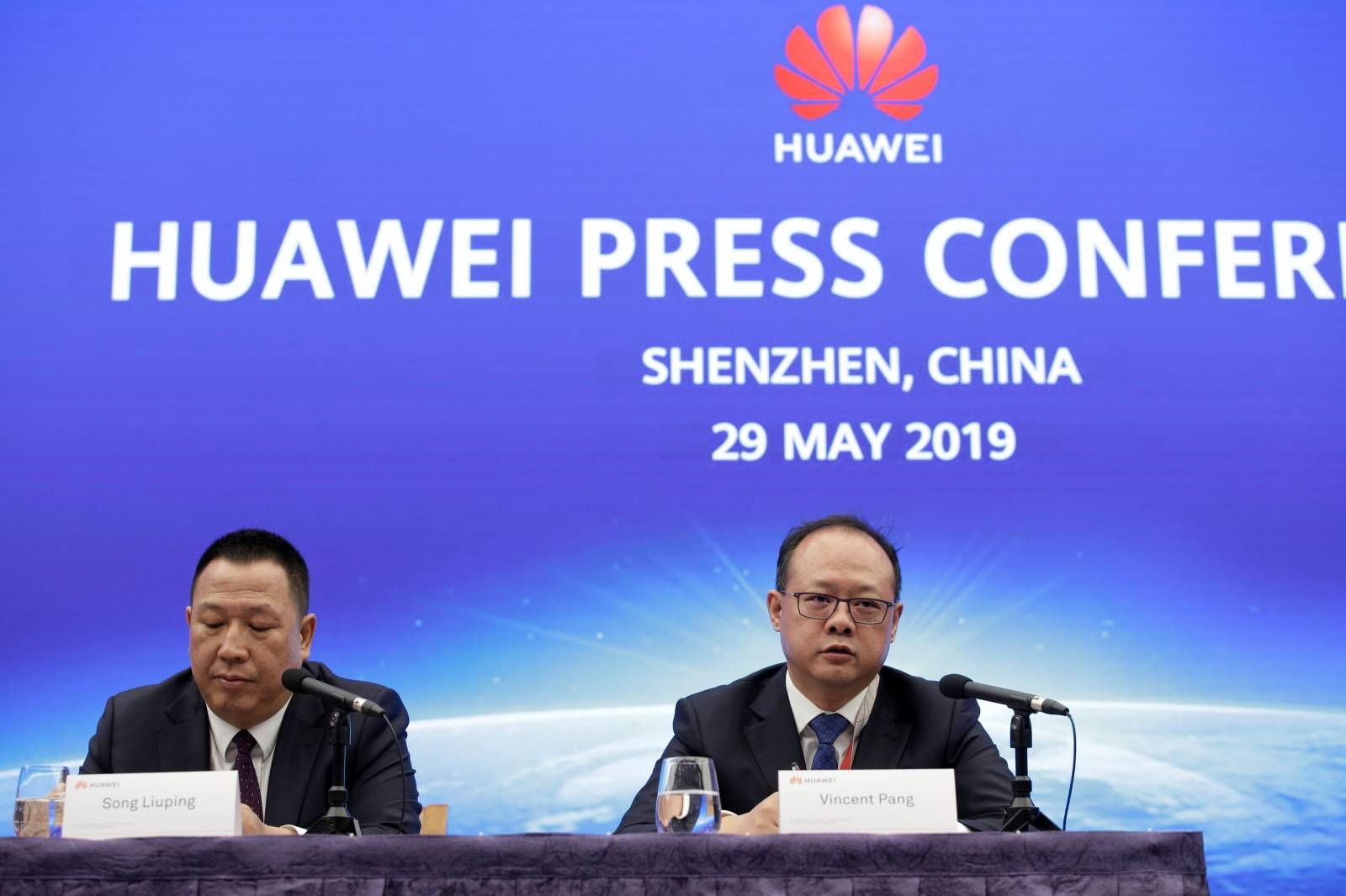 Huawei's Chief Legal Officer Song Liuping ( L) and Huawei's Western Europe President Vincent Pang attend a news conference in Shenzhen