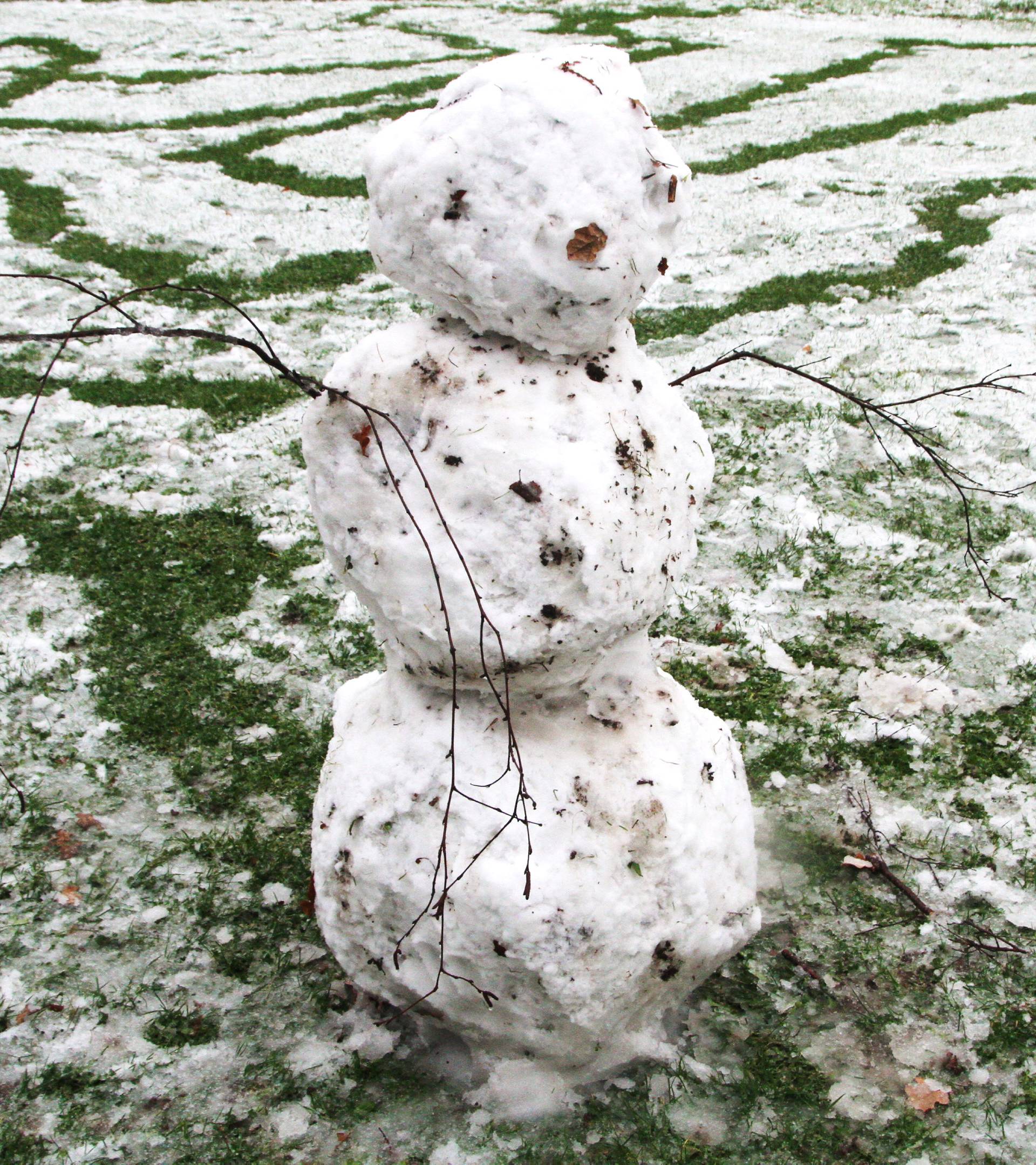 A snowman is seen in the snow in Thames Barrier Park, London