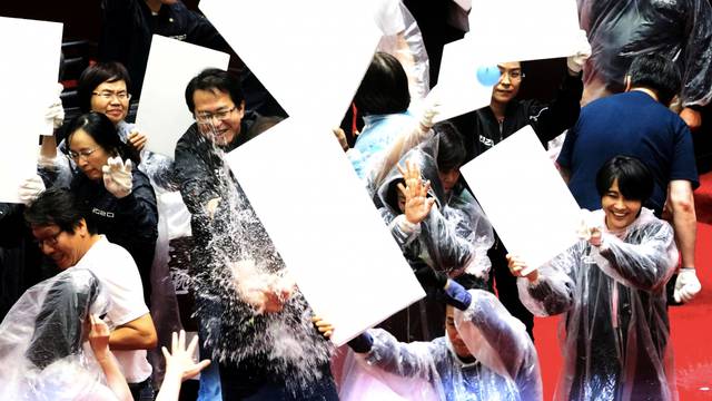 Lawmakers from Taiwan's ruling Democratic Progressive Party (DPP) with lawmakers from the main opposition Kuomintang (KMT) party throw water balloons at each other inside the parliament in Taipei