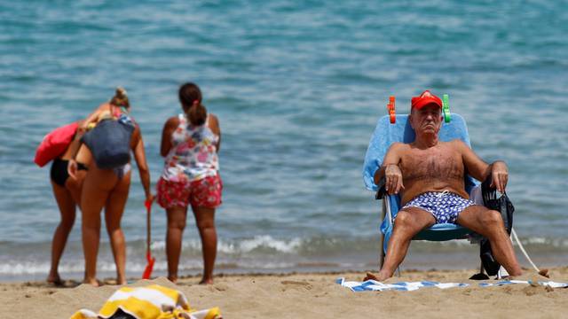 A man sunbathes on the Las Canteras beach as some Spanish provinces are allowed to ease lockdown restrictions during phase two, on the island of Gran Canaria