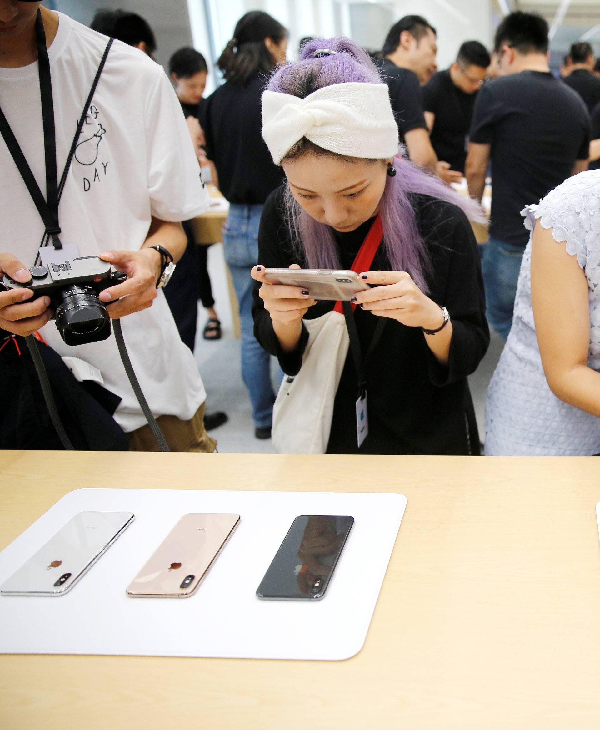 People experience new Apple's iPhone XS and iPhone XS Max during a media tour at an Apple office in Shanghai