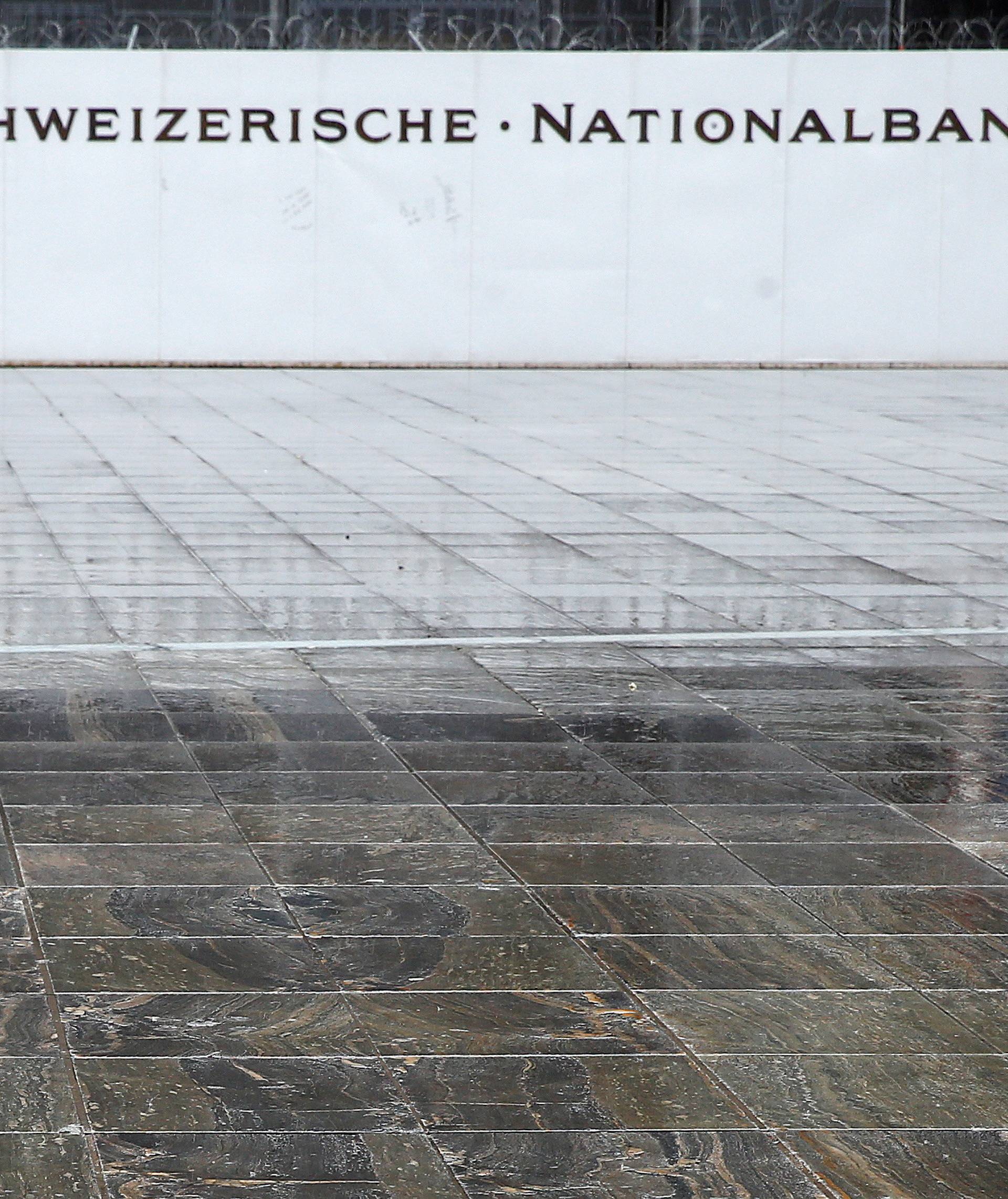A man walks on the Federal Square in front of the Swiss National Bank in Bern
