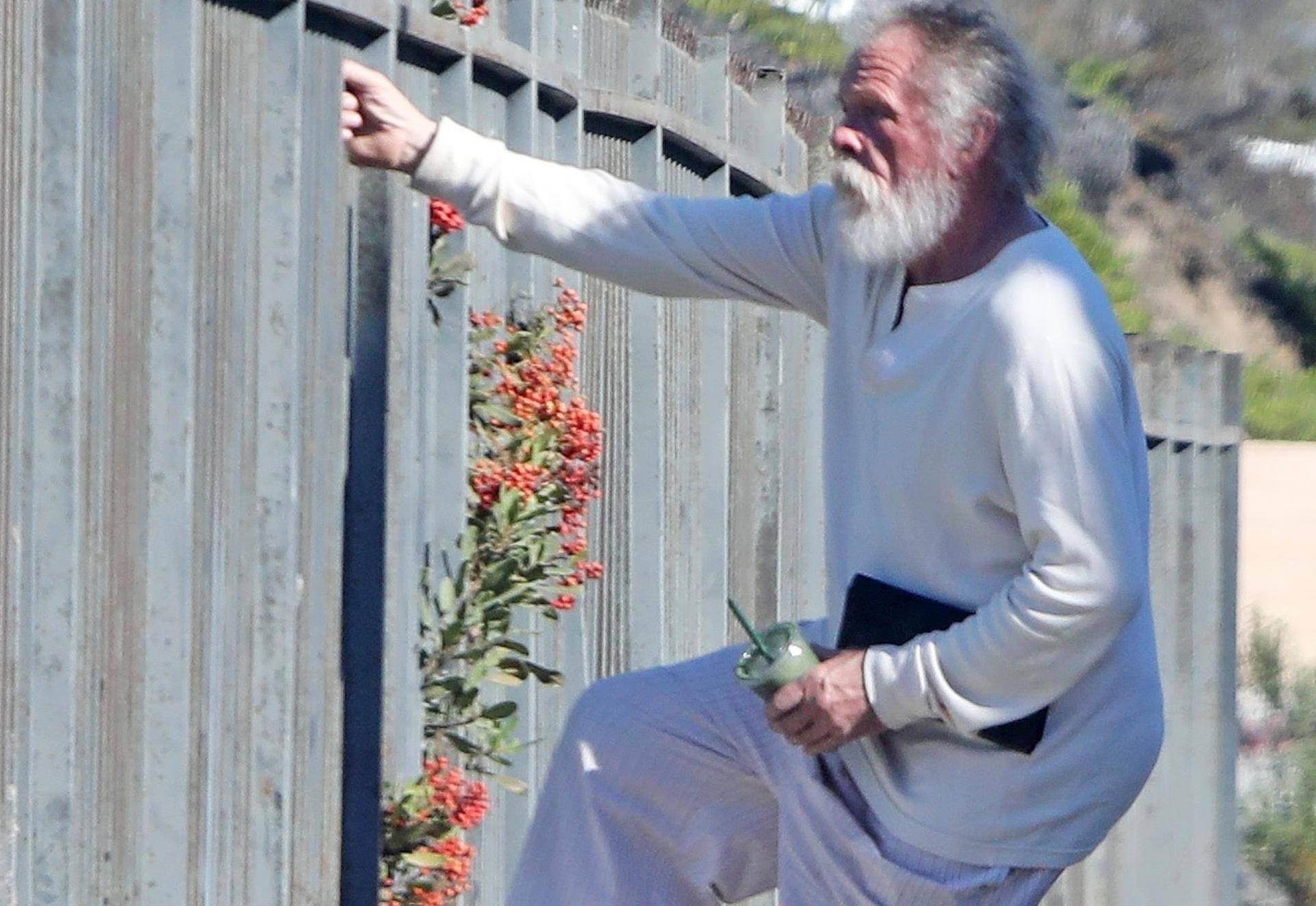 *EXCLUSIVE* Nick Nolte climbs a fence in his PJ's in Malibu