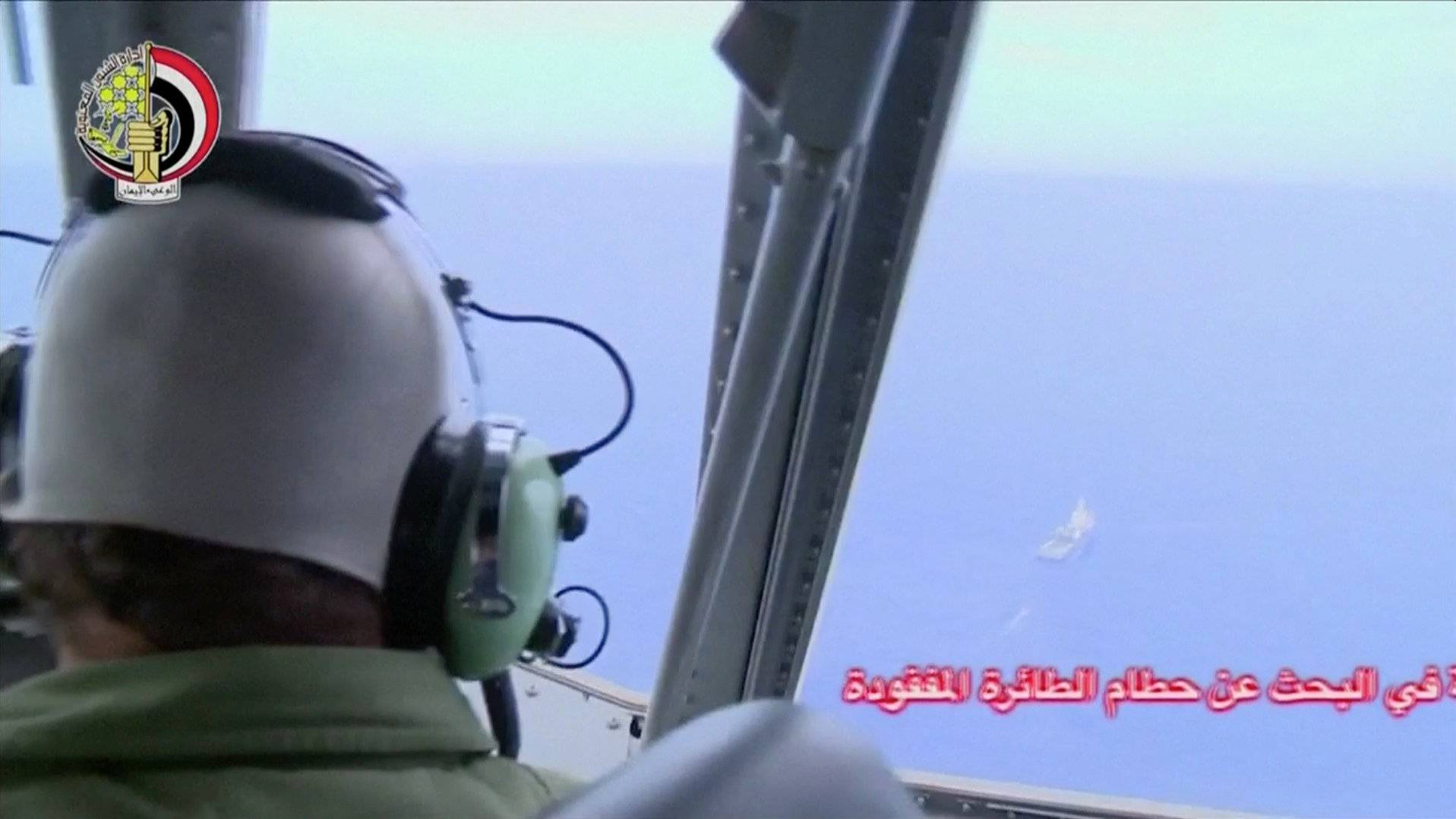 A pilot looks out of the cockpit during a search operation by Egyptian air and navy forces for the EgyptAir plane that disappeared in the Mediterranean Sea, in this still image taken from video