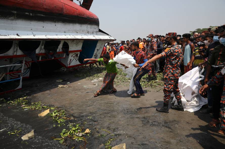 Relatives mourn after several people died due to the collision and sinking of a ferry at the Shitalakhsyaa River in Narayanganj