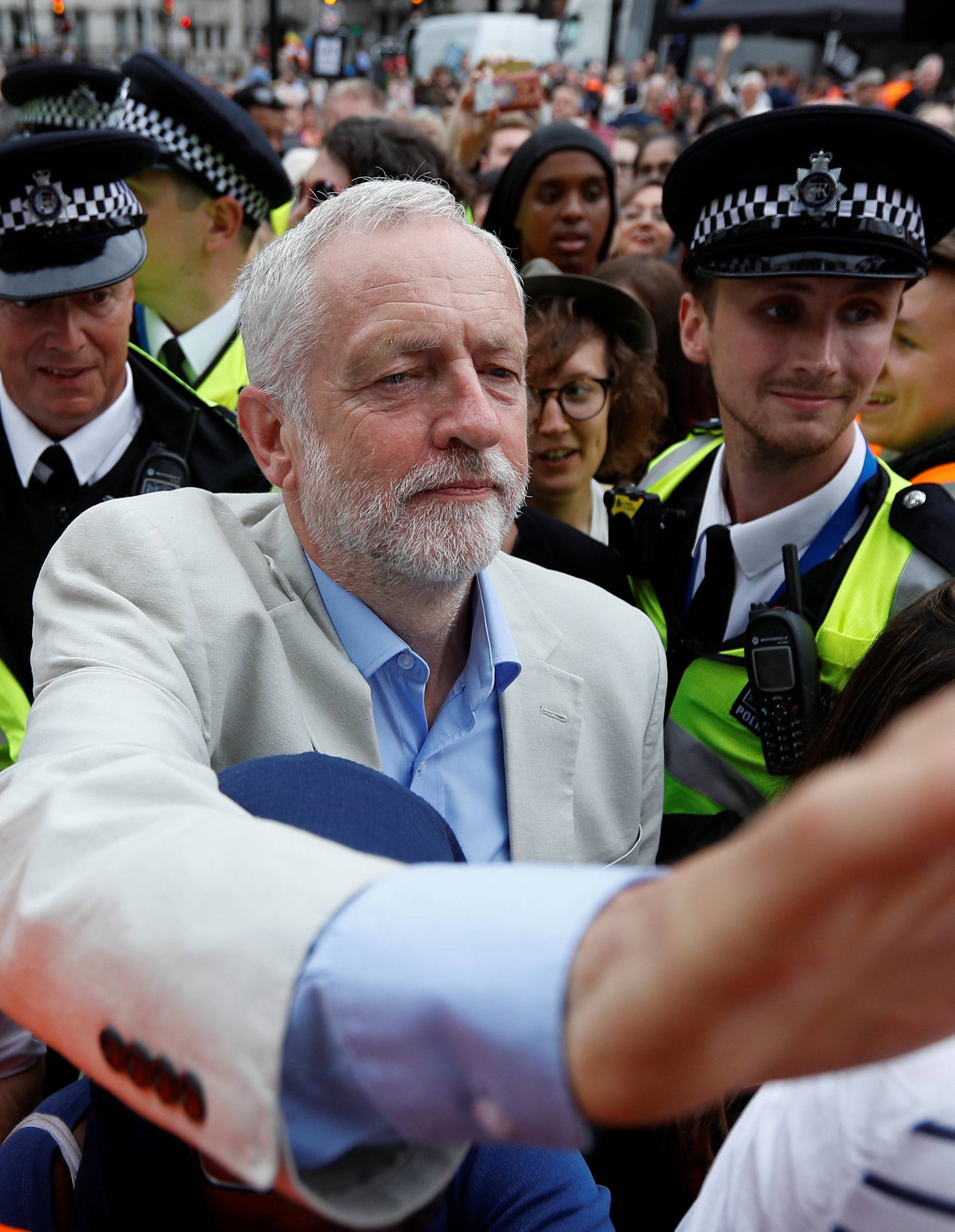 Britain's opposition Labour Party leader, Jeremy Corbyn, leaves after addressing an anti-austerity rally organised by campaigners Peoples' Assembly, in Parliament Square, in central London