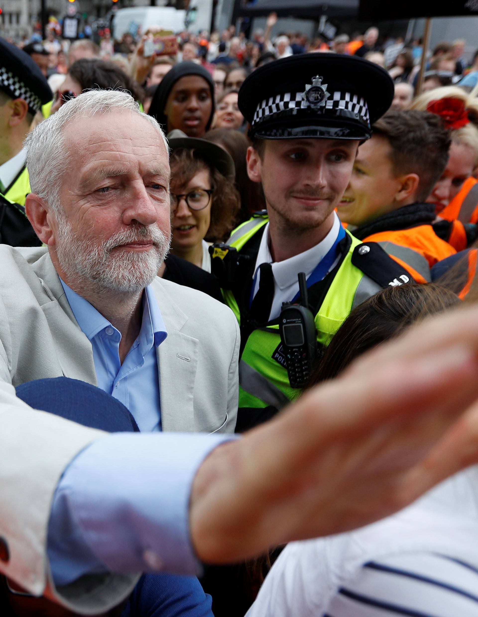 Britain's opposition Labour Party leader, Jeremy Corbyn, leaves after addressing an anti-austerity rally organised by campaigners Peoples' Assembly, in Parliament Square, in central London