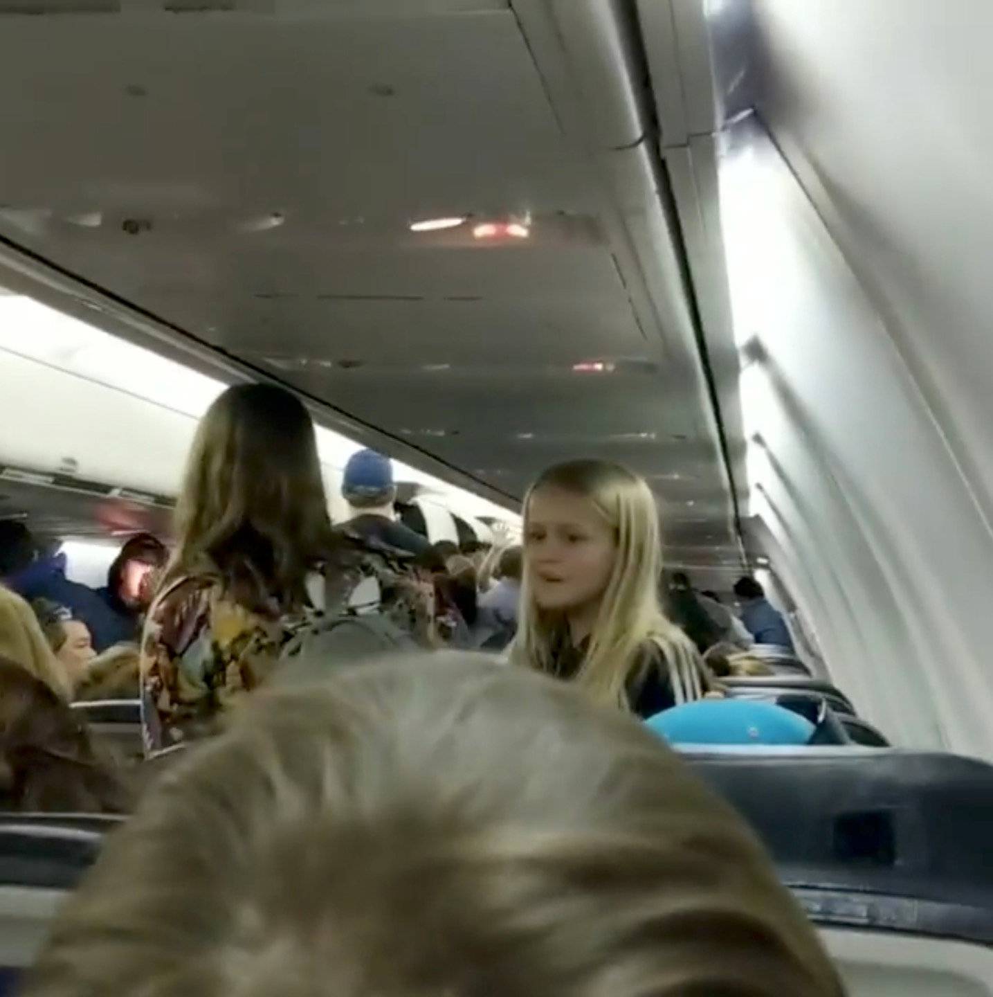 Passengers react in a plane that has collided with another plane at Toronto's Pearson Airport, Canada