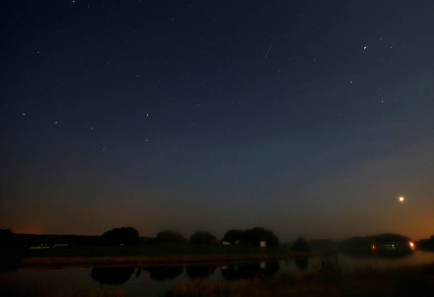 Meteor streaks past stars in the night sky during the annual Perseid meteor shower near the village of Prilepy