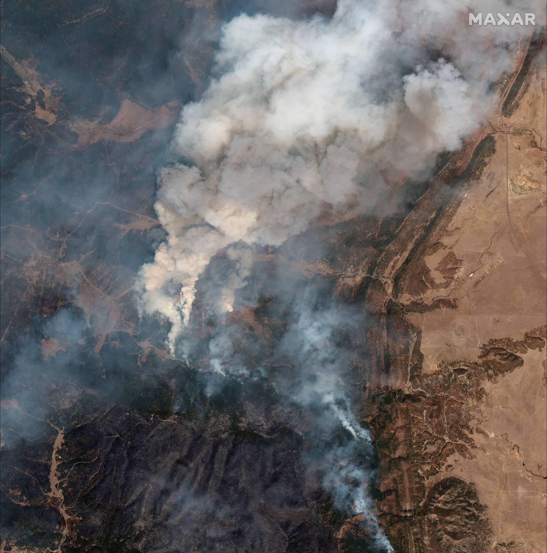 A satellite image shows a natural color overview of  fire lines of Hermits Peak wildfire, east of Santa Fe, New Mexico