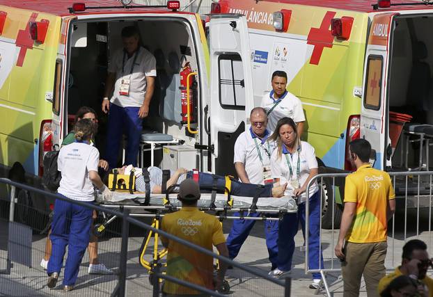 A woman is transported to an ambulance after being hit by an overhead television camera in Rio de Janeiro