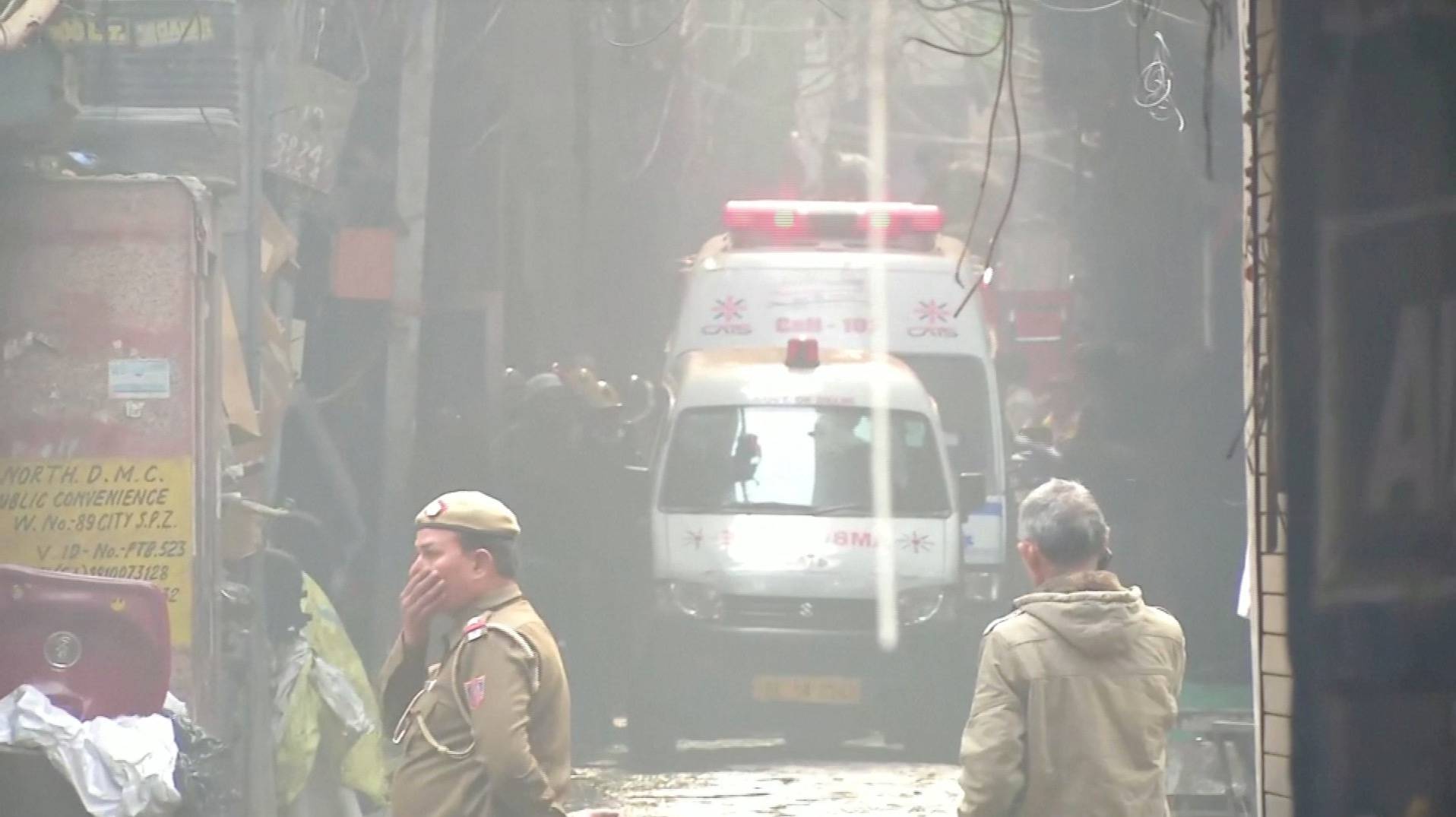 Video grab of ambulences at the scene of a deadly fire that swept through a factory where laborers were sleeping, in New Delhi