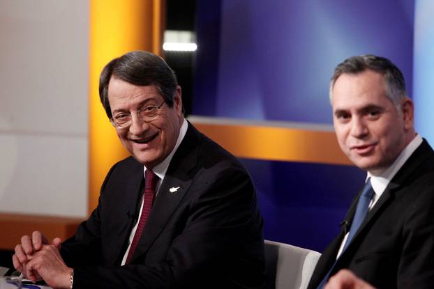 Cyprus Presidential candidate Nicos Anastasiades (L) of the right-wing Democratic Rally party and Nikolas Papadopoulos leader of the center-right DIKO party wait for a televised debate to go on air in Nicosia