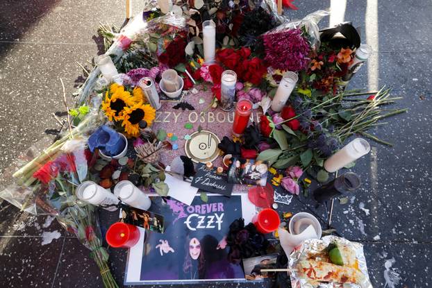 Flowers and pictures are placed on the star of late Ozzy Osbourne at the Hollywood Walk of Fame in Los Angeles