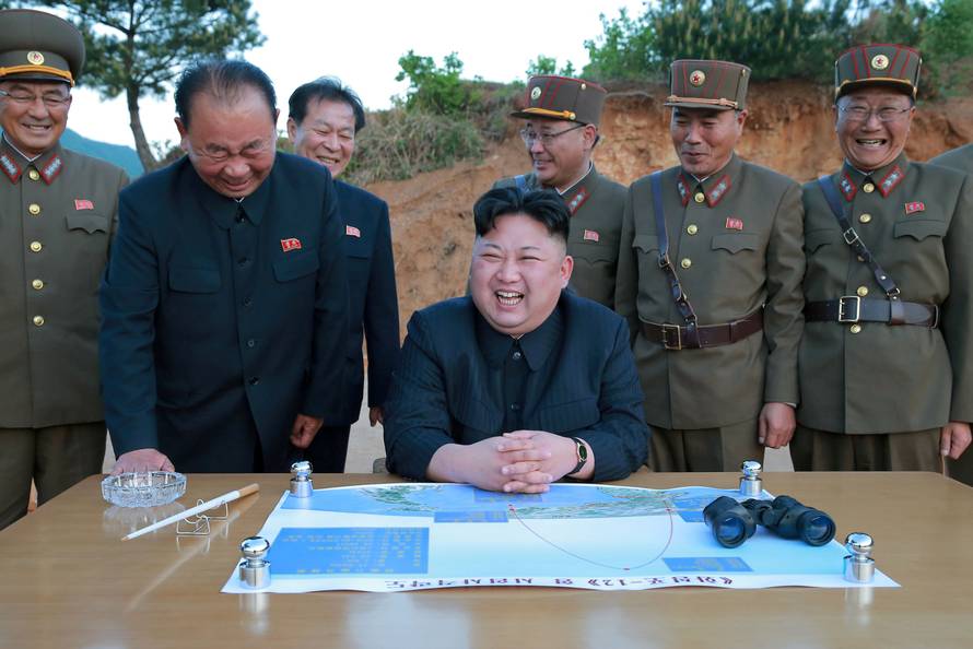 FILE PHOTO : North Korean leader Kim Jong Un reacts during the long-range strategic ballistic rocket Hwasong-12 (Mars-12) test launch