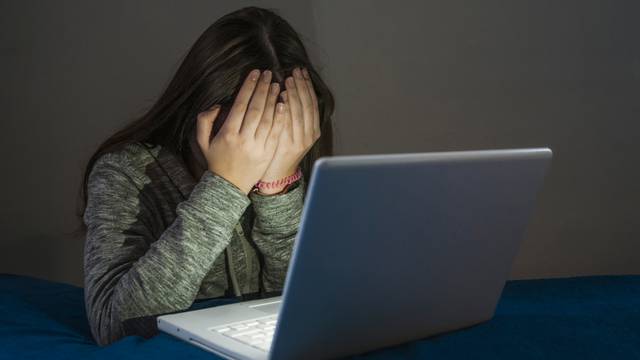 Sad,And,Scared,Female,Teenager,With,Computer,Laptop,Suffering,Cyberbullying