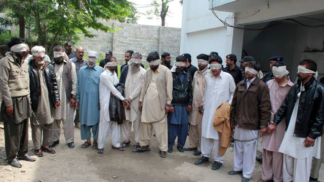 Members of a tribal council accused of ordering the burning death of a 16 year old girl are shown to the media after they were arrested by police in Donga Gali, outside Abbottabad