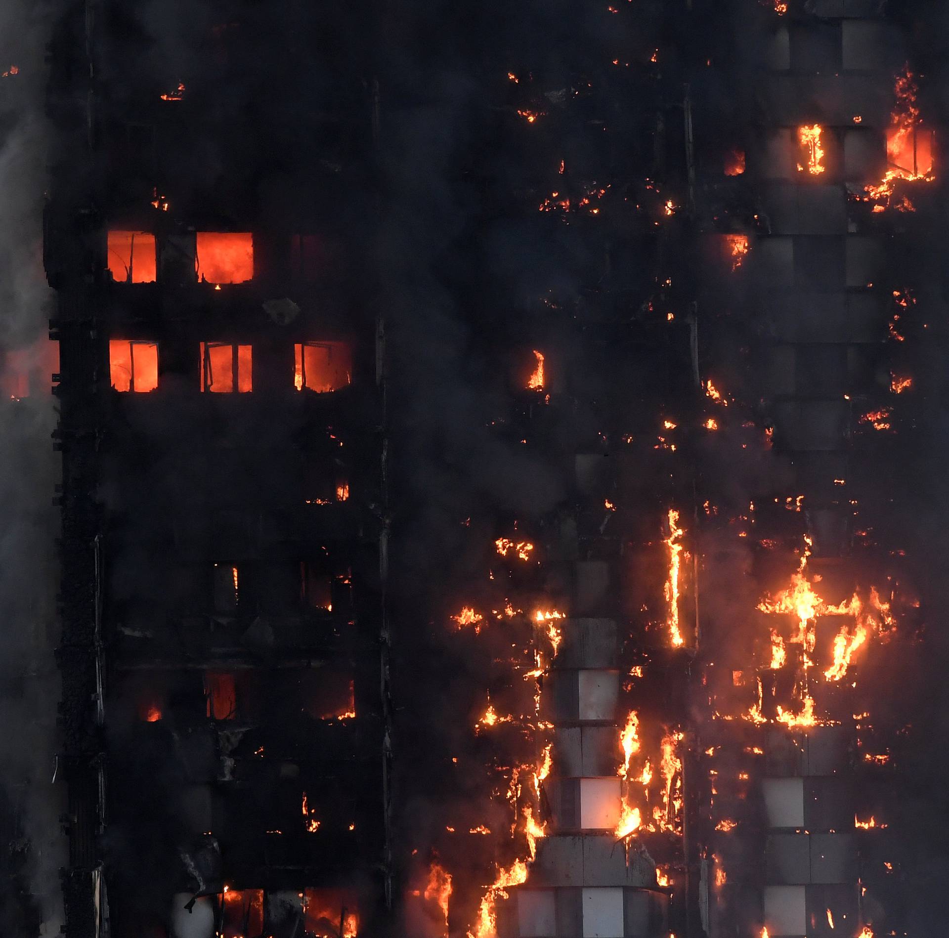 Flames and smoke engulf a tower block, in north Kensington, West London