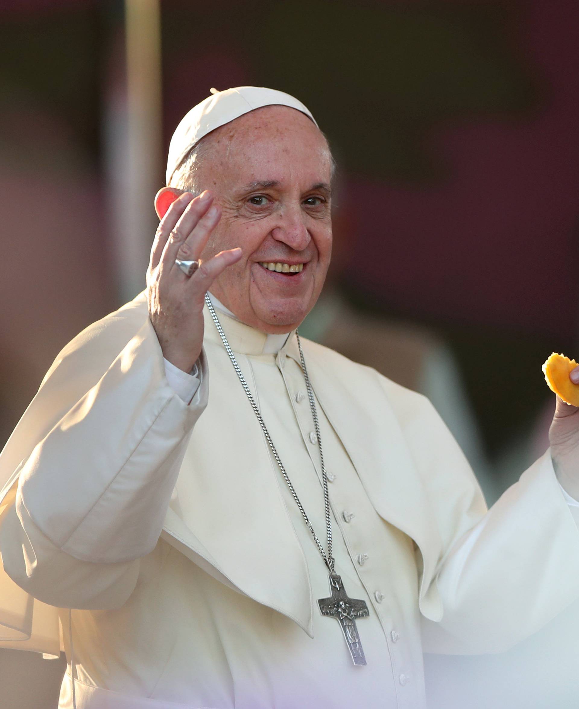 Pope Francis tries a sopaipilla, a typical Chilean pastry, at  the San Alberto Hurtado shrine, in Santiago