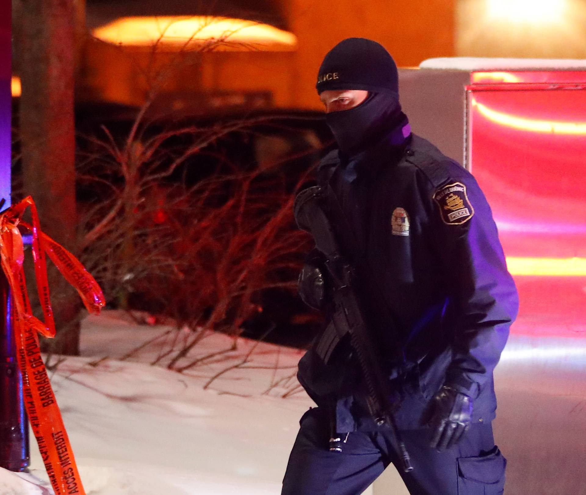 A police officer patrols the perimeter near a mosque after a shooting in Quebec City