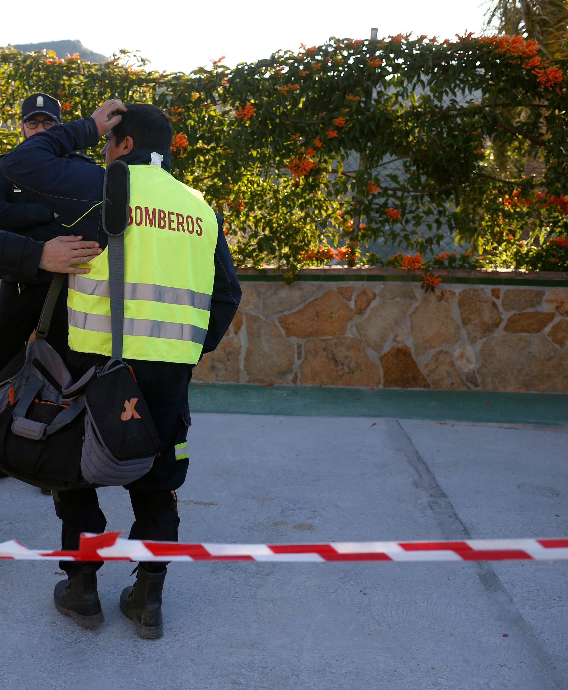 A firefighter reacts as he chats with Spanish regional police officers outside the control center after he left the area where Julen, a Spanish two-year-old boy, fell into a deep well, in Totalan
