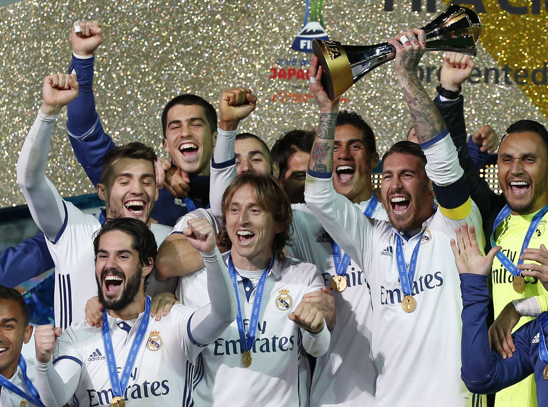 Real Madrid's Sergio Ramos and team mates celebrate winning the FIFA Club World Cup Final with the trophy