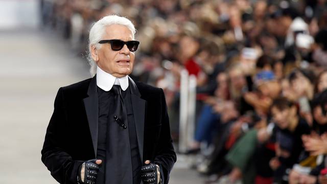 FILE PHOTO -  German designer Karl Lagerfeld appears at the end of his Spring/Summer 2014 women's ready-to-wear fashion show for French fashion house Chanel during Paris fashion week