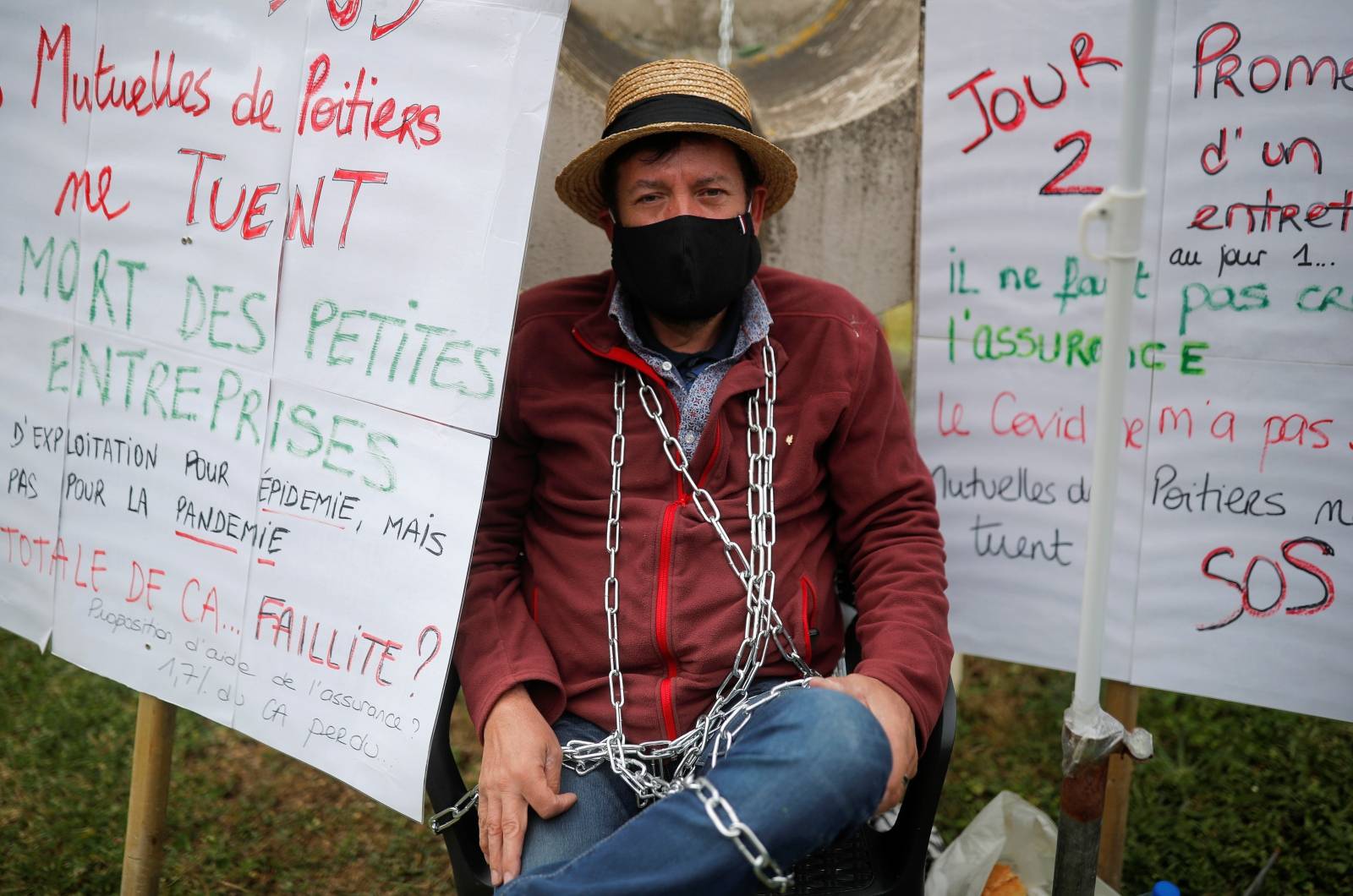 Martial Leotard, General Director of Les Ducs de Richelieu society, is seen chained in front of the Mutuelle de Poitiers Assurance, in Liguge