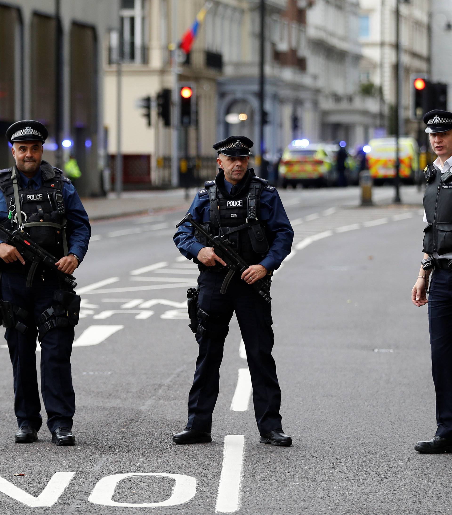 Police officers stand in the road outside the Natural History Museum, after a car mounted the pavement injuring a number of pedestrians, in London
