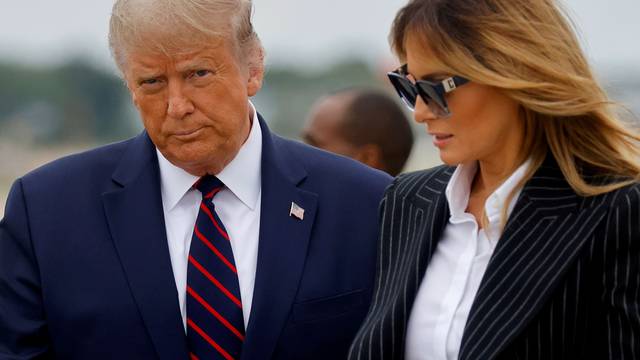 FILE PHOTO: U.S. President Donald Trump and first lady Melania Trump arrive at Cleveland Hopkins International Airport to participate in the first presidential debate with Democratic presidential nominee Joe Biden in Cleveland, Ohio