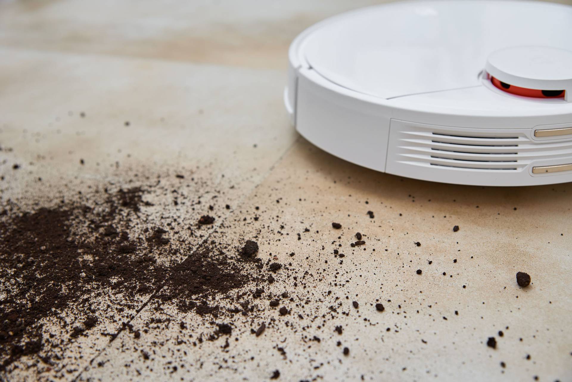 Robot vacuum cleaner cleans dirt on floor. Smart home concept