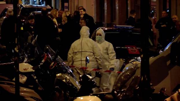 Personnel are seen at the scene of a knife attack in Paris