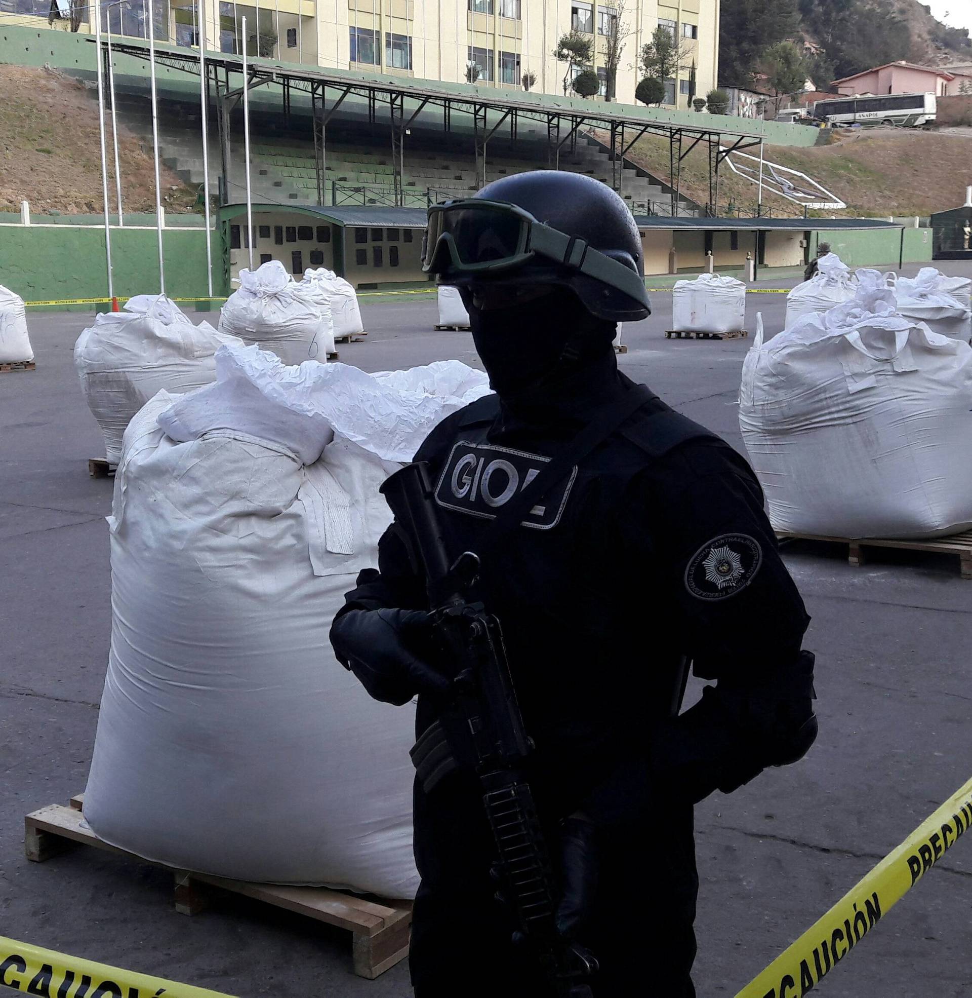A member of Bolivian Special Force of Fight against traffic of Narcotics FELCN stands next to bags of Cocaine at the police headquarter in La Paz