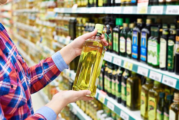 Buyer with sunflower oil in store